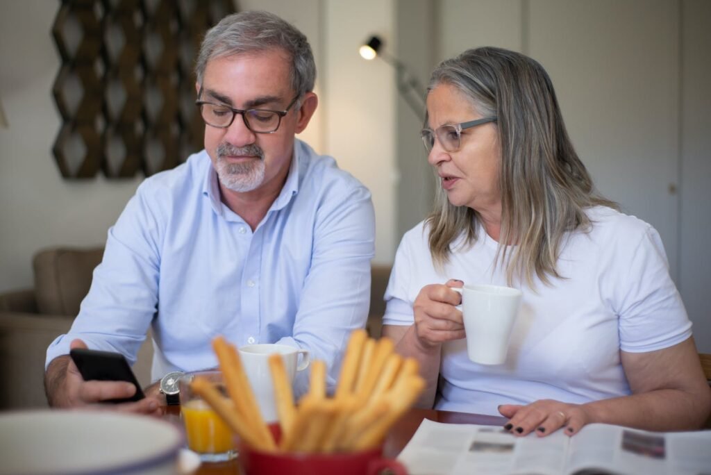 Couple Wearing Eyeglasses Looking at Phone Screen Together, Possibly Looking at a Google Business Profile
